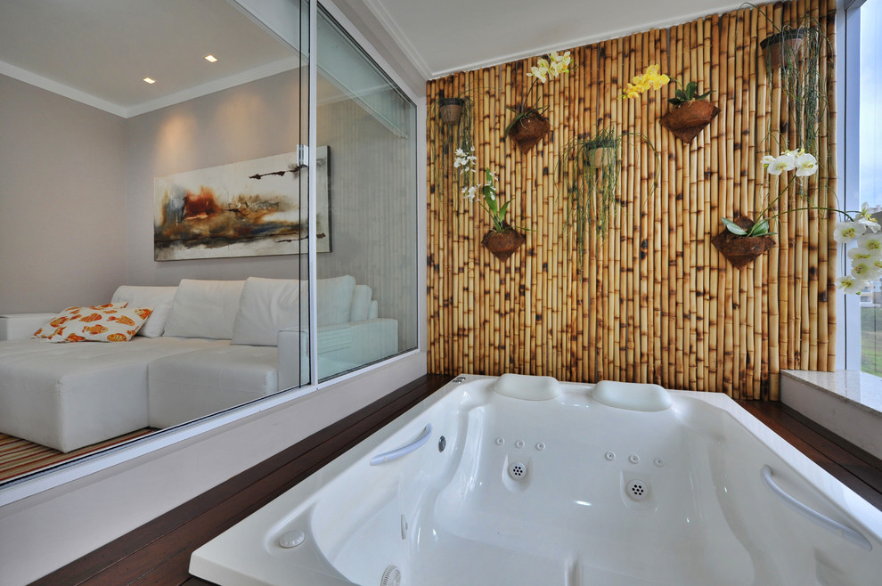 Photo of a contemporary bathroom in Other with a built-in bath, beige walls and dark hardwood flooring.