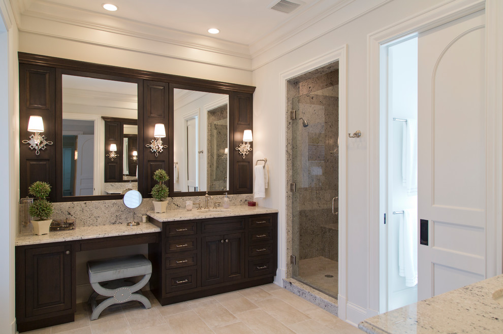 Large transitional master ceramic tile and beige floor bathroom photo in St Louis with louvered cabinets, dark wood cabinets, white walls, an undermount sink, granite countertops and a hinged shower door