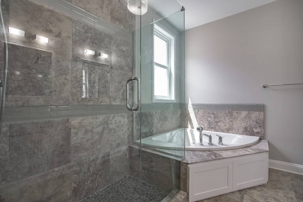 Photo of a contemporary ensuite bathroom in Chicago with shaker cabinets, white cabinets, a built-in bath, a corner shower, grey tiles, stone tiles, grey walls, travertine flooring, a submerged sink and granite worktops.