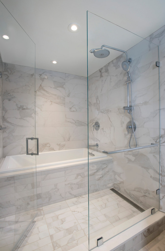 This is an example of a small modern ensuite bathroom in Boston with flat-panel cabinets, a built-in bath, a shower/bath combination, a wall mounted toilet, white tiles, porcelain tiles, white walls, porcelain flooring, a submerged sink, engineered stone worktops, white floors and a hinged door.