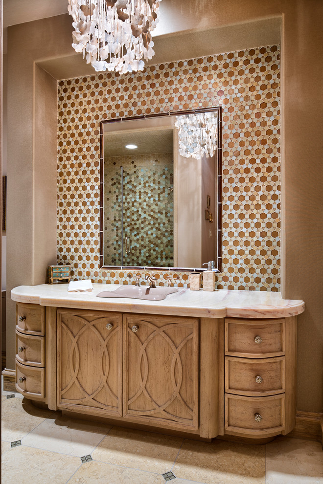 This is an example of a mediterranean bathroom in Houston with a built-in sink, medium wood cabinets, multi-coloured tiles, mosaic tiles and brown walls.