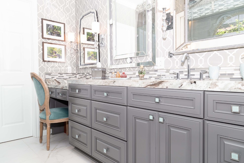 This is an example of a large contemporary ensuite bathroom in Houston with raised-panel cabinets, grey cabinets, a double shower, a two-piece toilet, grey tiles, mosaic tiles, grey walls, porcelain flooring, a submerged sink, marble worktops, white floors, a hinged door and grey worktops.