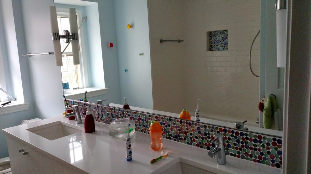 This is an example of a small modern family bathroom in DC Metro with a shower/bath combination, multi-coloured tiles and glass tiles.