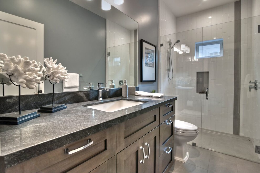 Inspiration for a modern bathroom in San Francisco with shaker cabinets, medium wood cabinets, a built-in shower, a two-piece toilet, white tiles, porcelain tiles, grey walls, porcelain flooring and granite worktops.