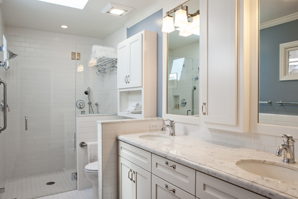 Elegant bathroom photo in San Francisco with white cabinets, an undermount sink and a hinged shower door