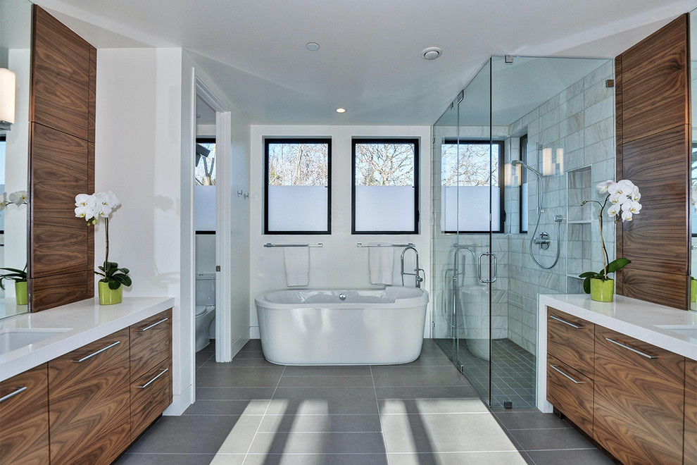 Inspiration for a contemporary bathroom in San Francisco with a submerged sink, flat-panel cabinets, dark wood cabinets, a freestanding bath, a built-in shower and white tiles.