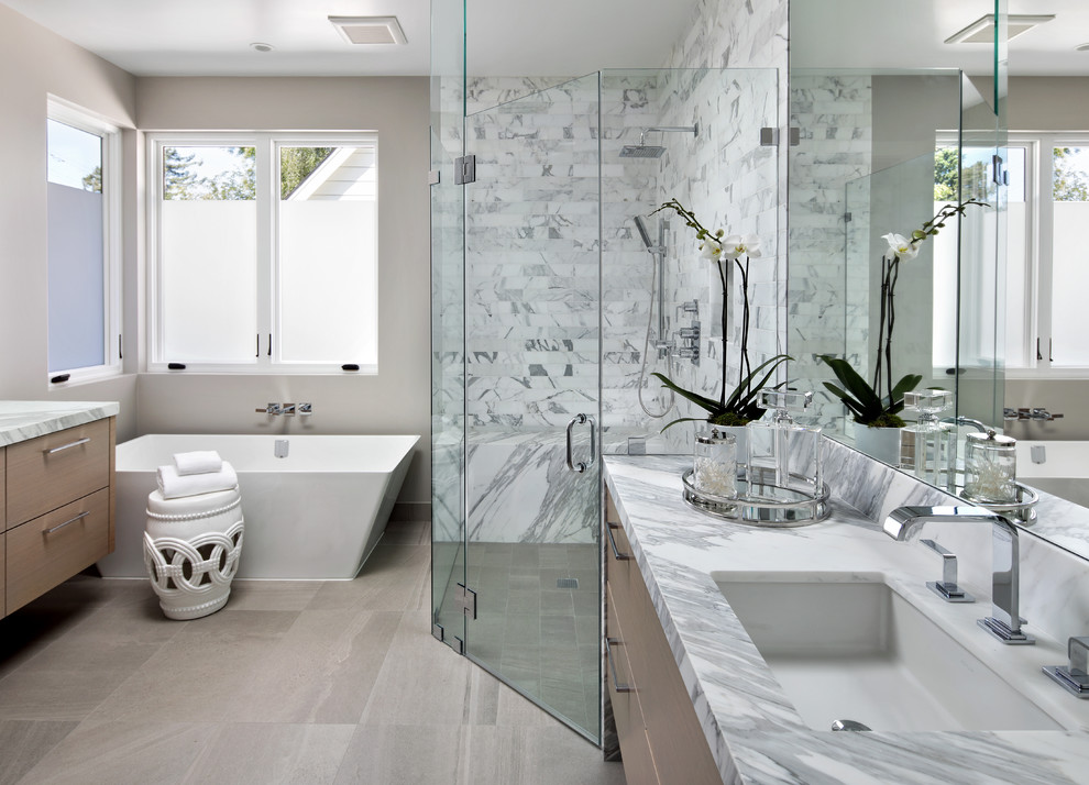 Bathroom - large contemporary master gray tile and subway tile porcelain tile and gray floor bathroom idea in San Francisco with flat-panel cabinets, light wood cabinets, beige walls, an undermount sink, quartzite countertops and a hinged shower door