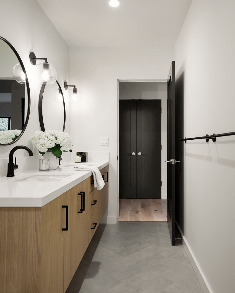 Small modern family bathroom in San Francisco with flat-panel cabinets, white cabinets, an alcove shower, a one-piece toilet, white tiles, ceramic tiles, white walls, porcelain flooring, a built-in sink, engineered stone worktops, grey floors, a hinged door, white worktops, a wall niche, double sinks and a floating vanity unit.