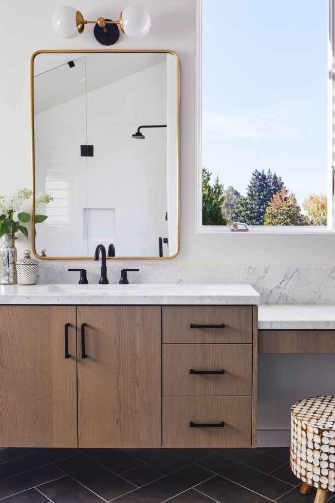 Photo of a contemporary bathroom in San Francisco with flat-panel cabinets, medium wood cabinets, white walls, a submerged sink, black floors and white worktops.