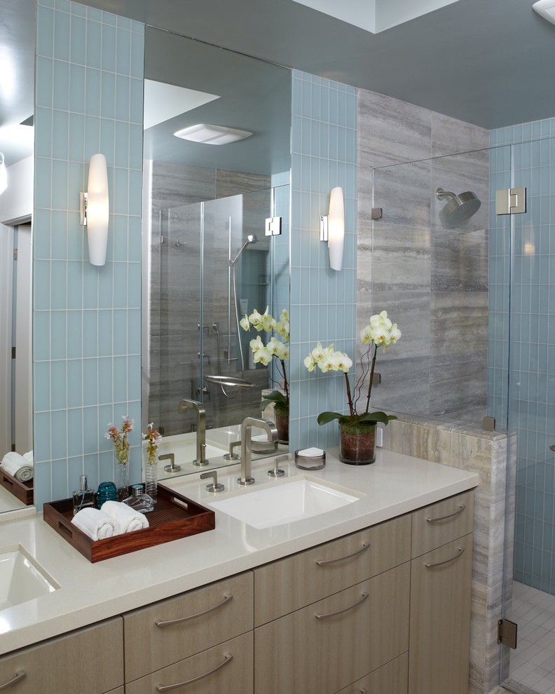 Inspiration for a mid-sized contemporary 3/4 blue tile and glass tile ceramic tile and beige floor alcove shower remodel in San Francisco with gray walls, beige cabinets, flat-panel cabinets, a two-piece toilet, an undermount sink, solid surface countertops and a hinged shower door