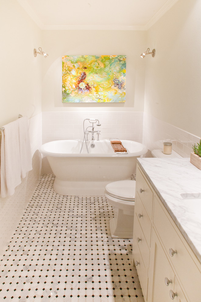 Mid-sized eclectic 3/4 white tile and subway tile marble floor and multicolored floor freestanding bathtub photo in Dallas with flat-panel cabinets, white cabinets, a two-piece toilet, white walls, an undermount sink and marble countertops