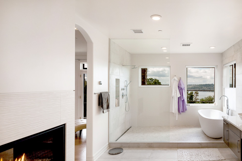 Photo of a large modern ensuite bathroom in Seattle with flat-panel cabinets, dark wood cabinets, a freestanding bath, a walk-in shower, grey tiles, ceramic tiles, white walls, porcelain flooring, a vessel sink and engineered stone worktops.