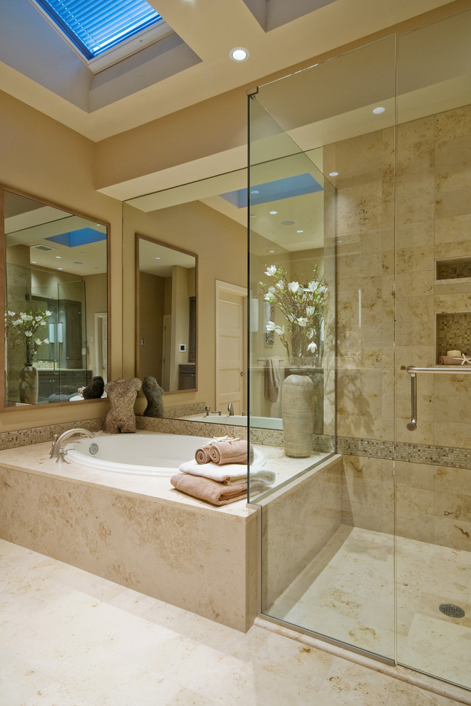 Cette image montre une salle de bain design avec une baignoire posée, une douche d'angle et un carrelage beige.