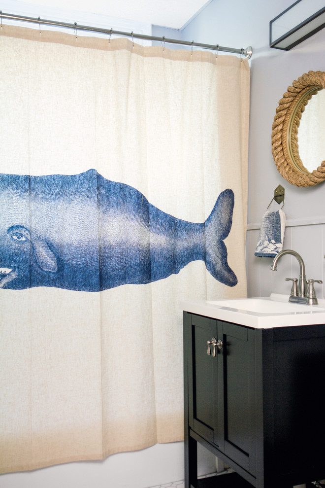 This is an example of a nautical bathroom in Portland Maine with a console sink, black cabinets, an alcove bath and a shower/bath combination.