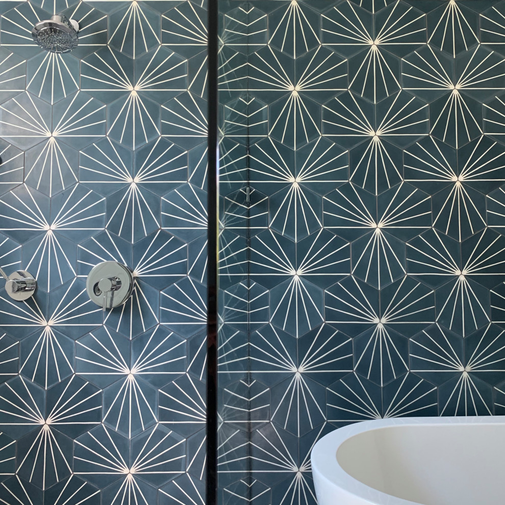 На фото: главная ванная комната в стиле модернизм с отдельно стоящей ванной, открытым душем, синей плиткой, цементной плиткой, синими стенами и открытым душем с