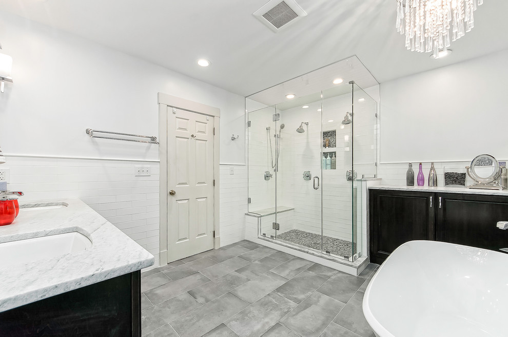 Inspiration for a mid-sized contemporary white tile and subway tile porcelain tile and gray floor bathroom remodel in Columbus with recessed-panel cabinets, black cabinets, gray walls, an undermount sink and a hinged shower door