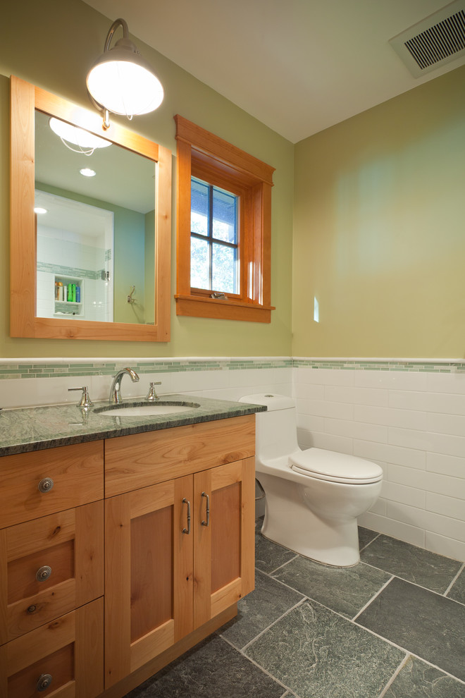 Example of a classic white tile and ceramic tile slate floor and gray floor alcove shower design in Vancouver with shaker cabinets, beige cabinets, green walls, an undermount sink, granite countertops, a hinged shower door and green countertops