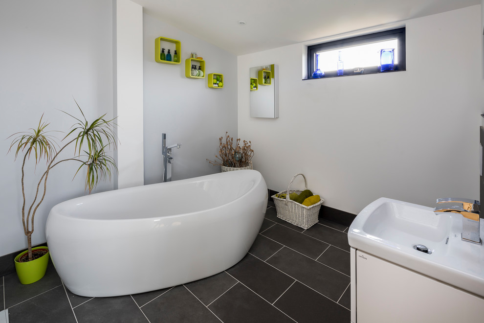 Medium sized contemporary family bathroom in Essex with flat-panel cabinets, white cabinets, a freestanding bath, white tiles, slate tiles, white walls, slate flooring and grey floors.