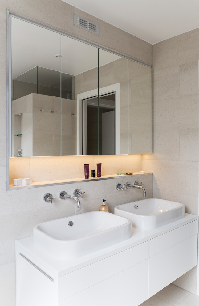 Design ideas for a small contemporary family bathroom in London with flat-panel cabinets, white cabinets, beige tiles, cement tiles, beige walls, cement flooring, quartz worktops, beige floors and a vessel sink.