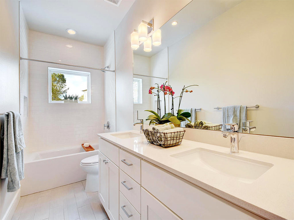 Photo of a medium sized contemporary bathroom in Austin with recessed-panel cabinets, white cabinets, an alcove bath, a shower/bath combination, ceramic flooring, a submerged sink, a one-piece toilet, ceramic tiles, red walls, engineered stone worktops, beige floors, an open shower and white worktops.