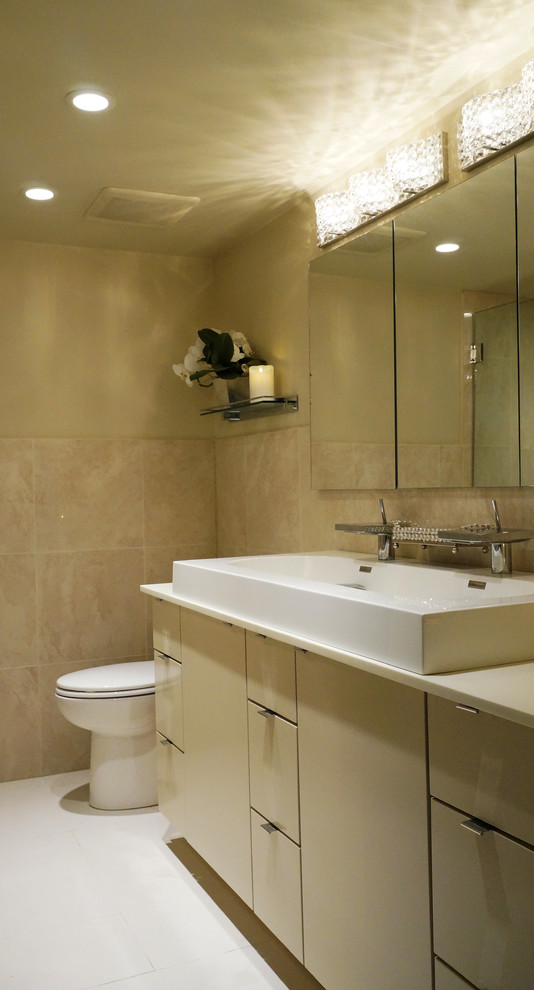 Mid-sized trendy master ceramic tile bathroom photo in Chicago with flat-panel cabinets, white cabinets, a two-piece toilet, beige walls and a trough sink