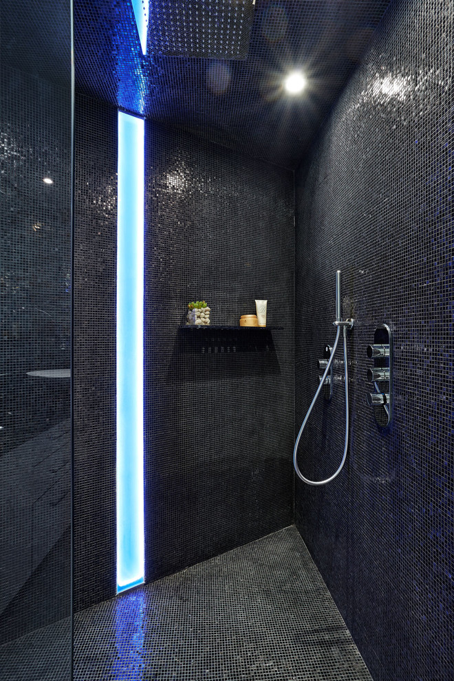 Cette image montre une salle de bain principale minimaliste de taille moyenne avec une vasque, des portes de placard blanches, une douche d'angle, mosaïque et un mur bleu.