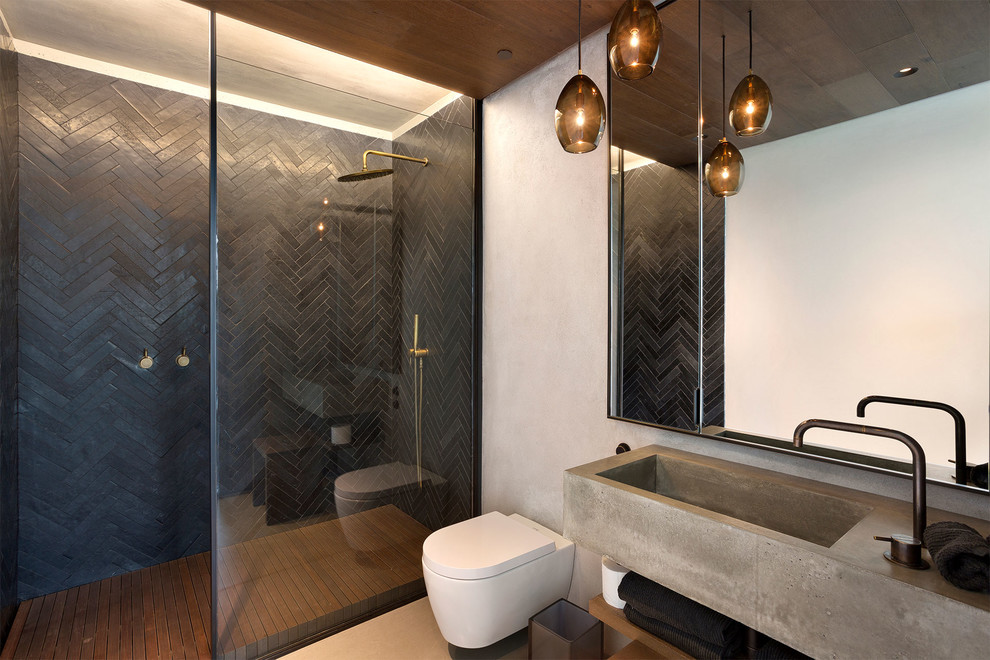 Example of a mid-sized trendy master medium tone wood floor and brown floor bathroom design in Miami with beige walls, a trough sink, wood countertops, open cabinets, medium tone wood cabinets, a wall-mount toilet and gray countertops