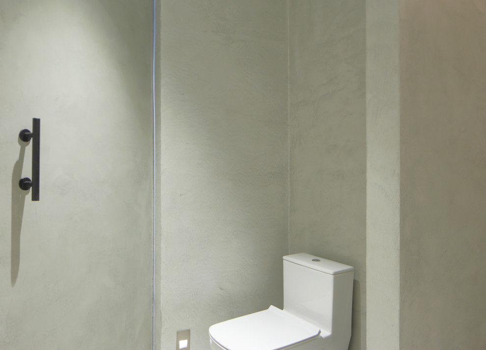 Ispirazione per una stanza da bagno design con doccia ad angolo, pareti grigie, pavimento in cemento, lavabo integrato, top in cemento e doccia aperta