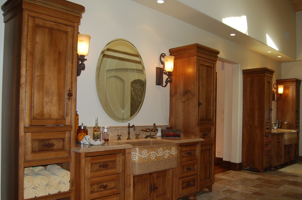 Inspiration for an expansive mediterranean ensuite bathroom in Sacramento with freestanding cabinets, medium wood cabinets, marble worktops, a built-in bath, a walk-in shower, beige tiles, beige walls and limestone flooring.