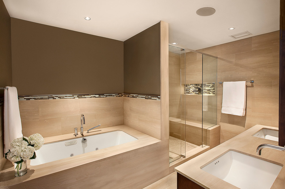 Large modern ensuite bathroom in Chicago with a submerged sink, dark wood cabinets, onyx worktops, a submerged bath, an alcove shower, a wall mounted toilet, beige tiles, stone tiles, beige walls, marble flooring and flat-panel cabinets.