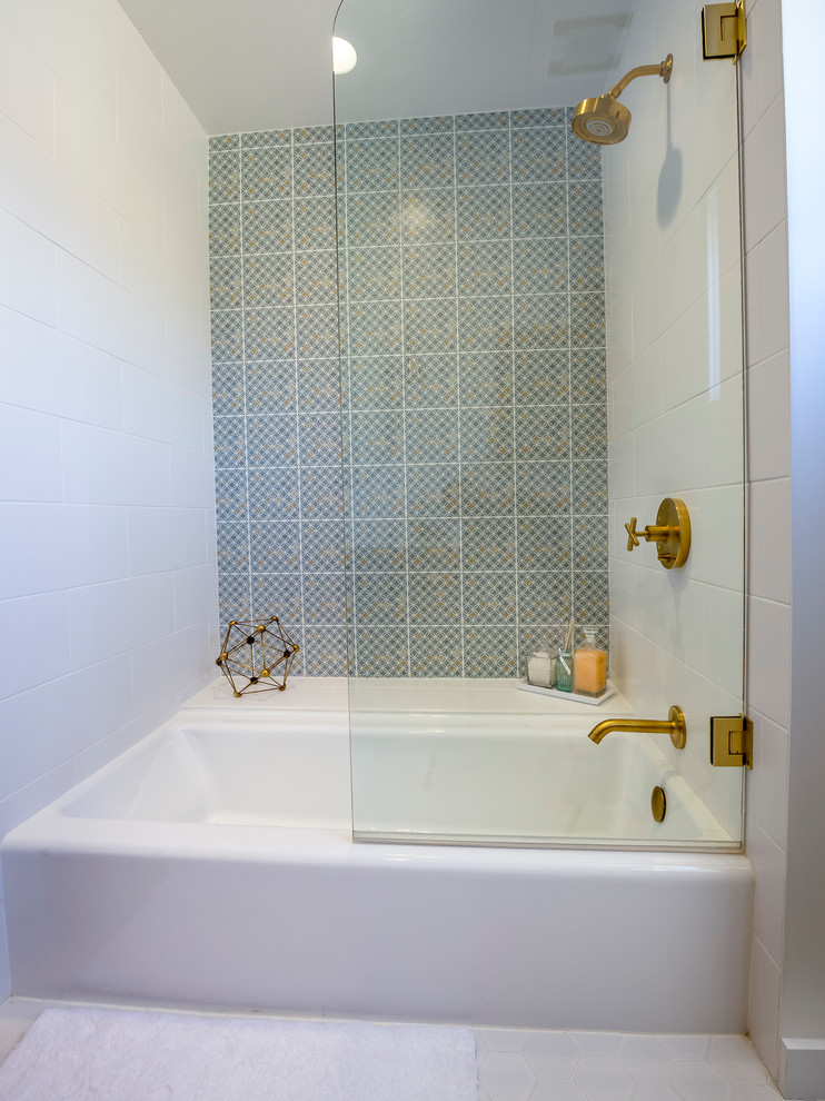 Photo of a medium sized retro bathroom in Los Angeles with medium wood cabinets, a shower/bath combination, white tiles, ceramic tiles, white walls, engineered stone worktops, a built-in bath, a two-piece toilet, porcelain flooring, a submerged sink, white floors and a hinged door.