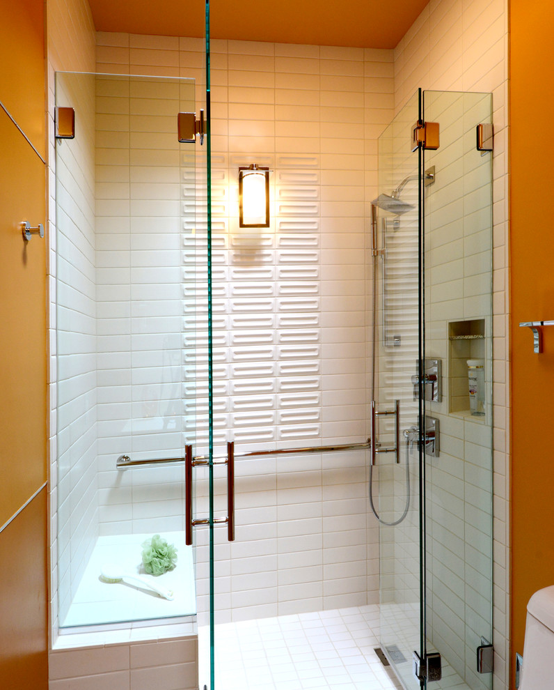 Idée de décoration pour une douche en alcôve design en bois brun de taille moyenne avec un placard à porte plane, un mur jaune, sol en stratifié, un lavabo intégré, un plan de toilette en carrelage et une cabine de douche à porte battante.