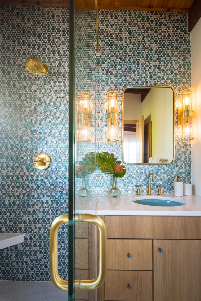 Example of a mid-sized 1960s master blue tile and glass tile light wood floor and white floor corner shower design in Seattle with flat-panel cabinets, light wood cabinets, a bidet, white walls, a wall-mount sink, quartzite countertops and a hinged shower door
