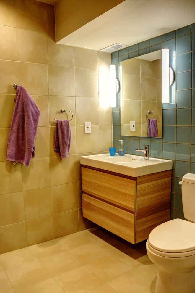 Example of a mid-century modern 3/4 blue tile and glass tile ceramic tile and beige floor bathroom design in Seattle with a two-piece toilet and an integrated sink