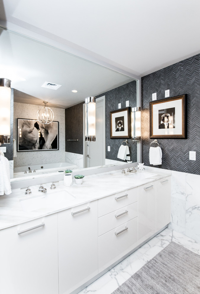 На фото: главная ванная комната среднего размера в современном стиле с плоскими фасадами, белыми фасадами, накладной ванной, белой плиткой, каменной плиткой, серыми стенами, мраморным полом, врезной раковиной и мраморной столешницей