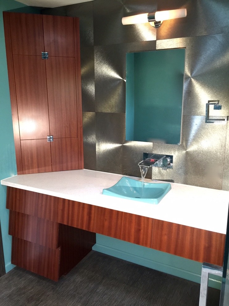 Mid-sized mid-century modern master gray tile and porcelain tile limestone floor bathroom photo in Los Angeles with a drop-in sink, flat-panel cabinets, medium tone wood cabinets, quartz countertops, a one-piece toilet and blue walls