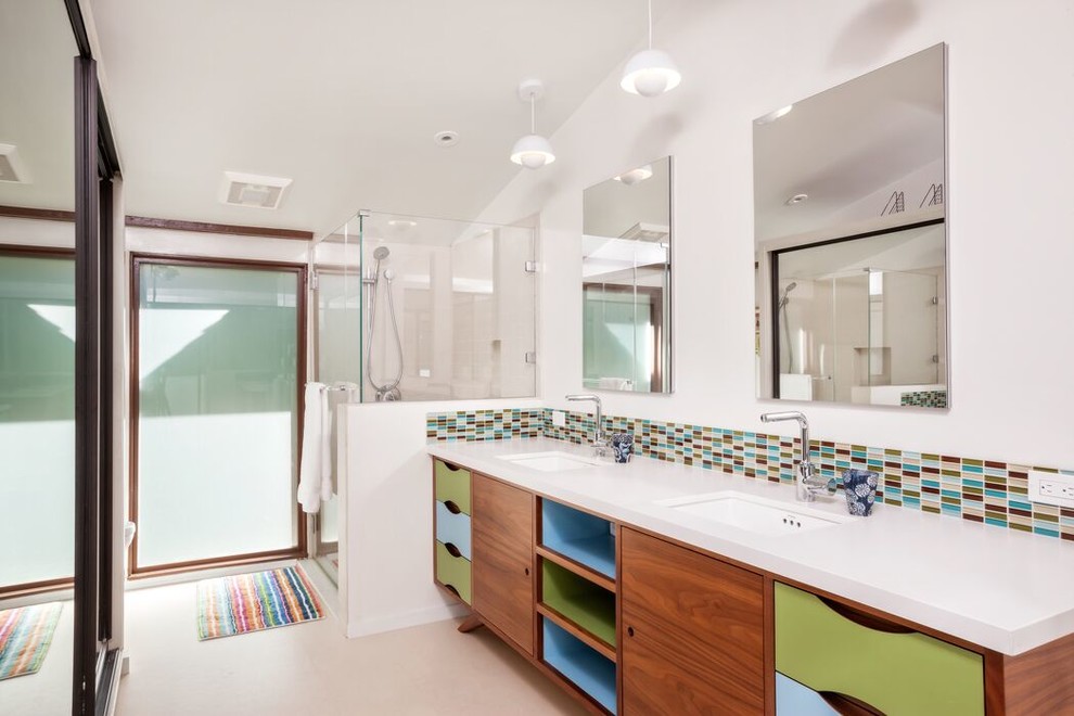 Medium sized retro shower room bathroom in Los Angeles with flat-panel cabinets, medium wood cabinets, an alcove shower, beige tiles, blue tiles, brown tiles, grey tiles, green tiles, ceramic tiles, white walls, porcelain flooring, a submerged sink, solid surface worktops, beige floors and a hinged door.