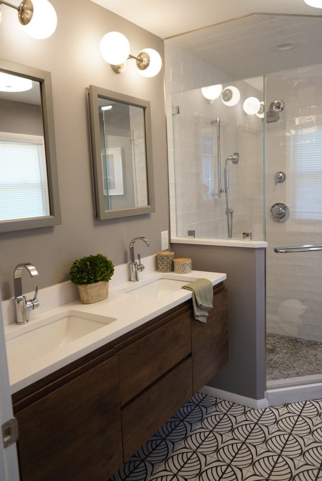 Medium sized eclectic ensuite bathroom in Philadelphia with freestanding cabinets, dark wood cabinets, a corner shower, a two-piece toilet, black and white tiles, metro tiles, grey walls, cement flooring, a submerged sink, engineered stone worktops, white floors, a hinged door and white worktops.