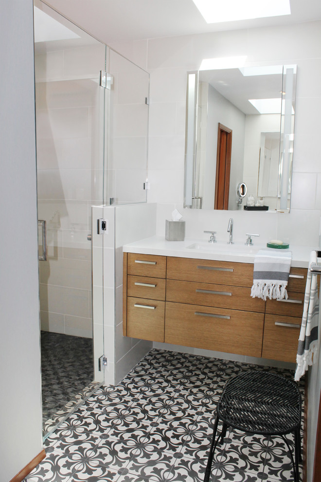 Example of a large mid-century modern master white tile and porcelain tile cement tile floor and multicolored floor alcove shower design in Los Angeles with flat-panel cabinets, medium tone wood cabinets, white walls, an undermount sink, quartz countertops and a hinged shower door