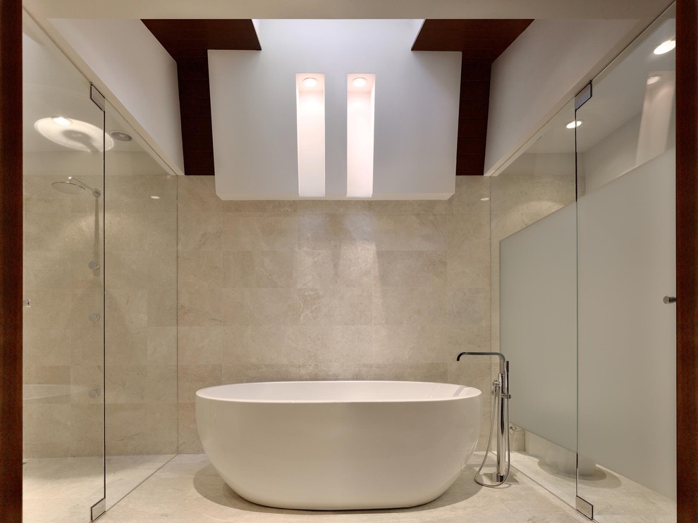 Photo of a medium sized contemporary ensuite bathroom in Atlanta with flat-panel cabinets, dark wood cabinets, a freestanding bath, an alcove shower, beige tiles, travertine tiles, beige walls, light hardwood flooring, an integrated sink, stainless steel worktops, brown floors and a hinged door.