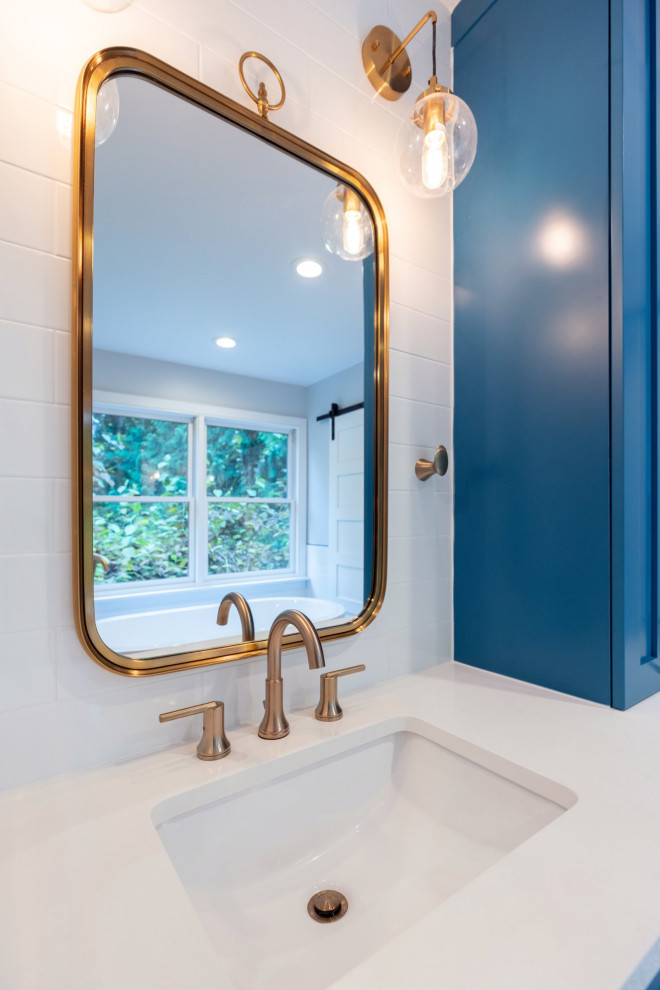 Стильный дизайн: большая главная ванная комната в стиле ретро с фасадами в стиле шейкер, синими фасадами, отдельно стоящей ванной, белой плиткой, плиткой кабанчик, белыми стенами, полом из цементной плитки, столешницей из кварцита, душем с распашными дверями и белой столешницей - последний тренд