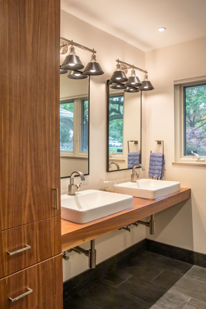 This is an example of a medium sized midcentury ensuite bathroom in Indianapolis with white walls, porcelain flooring, a vessel sink, wooden worktops, grey floors and brown worktops.