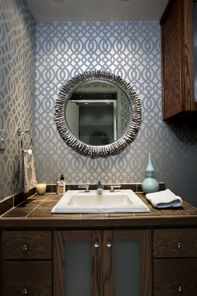 Inspiration for a 1960s 3/4 gray tile bathroom remodel in Seattle with tile countertops, multicolored walls, a drop-in sink, glass-front cabinets and dark wood cabinets