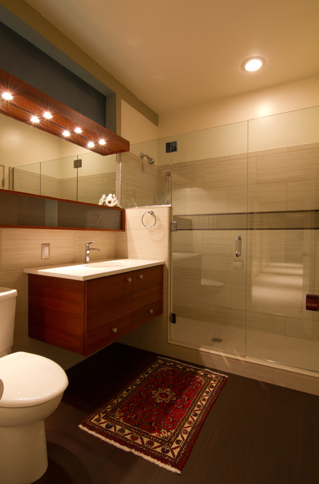 Alcove shower - contemporary beige tile alcove shower idea in Portland with flat-panel cabinets, dark wood cabinets and a two-piece toilet