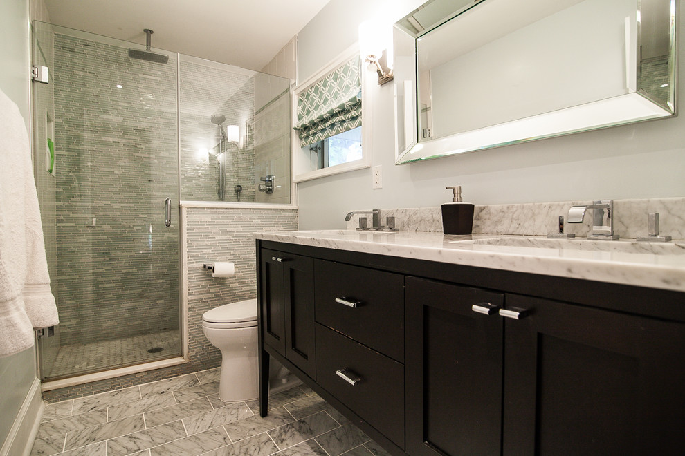 Inspiration for a mid-sized 1960s 3/4 gray tile and mosaic tile marble floor alcove shower remodel in New York with an undermount sink, shaker cabinets, dark wood cabinets, marble countertops, a one-piece toilet and blue walls