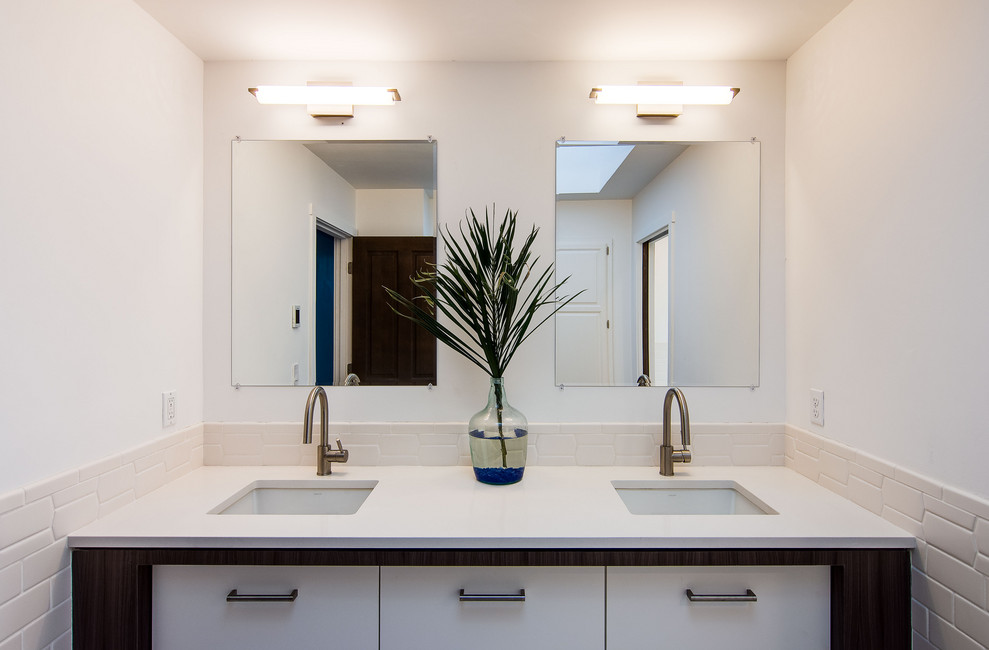 Expansive retro family bathroom in Portland with flat-panel cabinets, white cabinets, a two-piece toilet, white tiles, porcelain tiles, white walls, an integrated sink, white worktops, a freestanding bath, a double shower, ceramic flooring, engineered stone worktops, white floors, a sliding door, double sinks and a freestanding vanity unit.