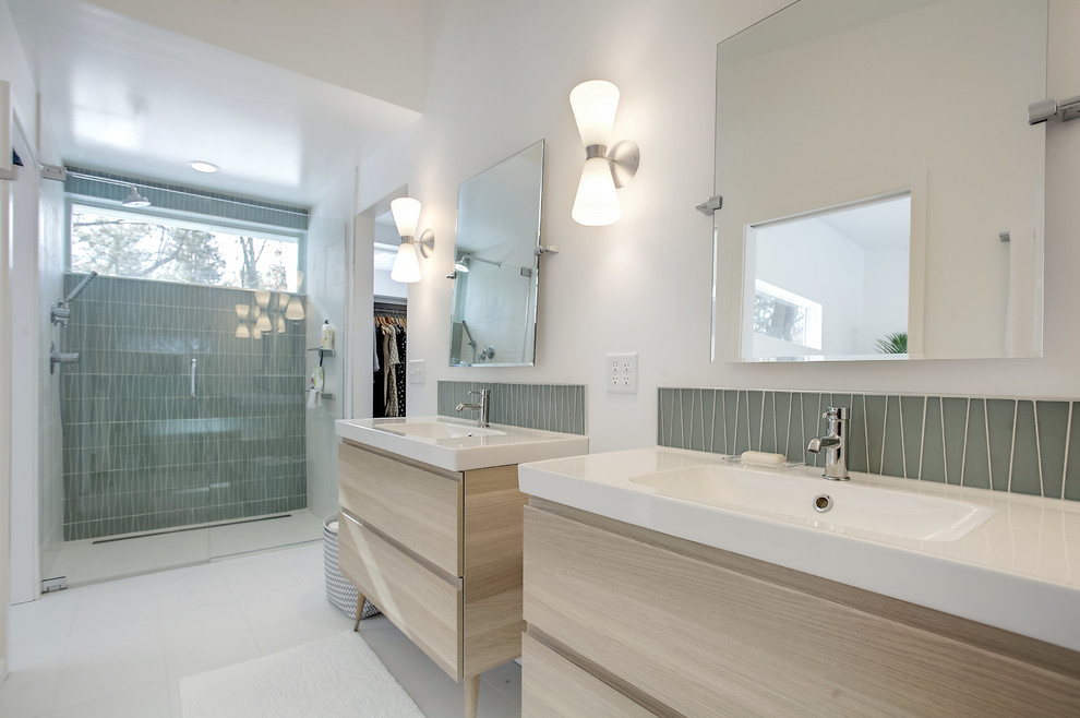 Aménagement d'une salle de bain principale rétro en bois clair de taille moyenne avec un placard à porte plane, une douche à l'italienne, un carrelage vert, un carrelage en pâte de verre, un sol en carrelage de céramique, un lavabo intégré, un sol blanc, une cabine de douche à porte battante, un mur blanc et un plan de toilette en quartz.