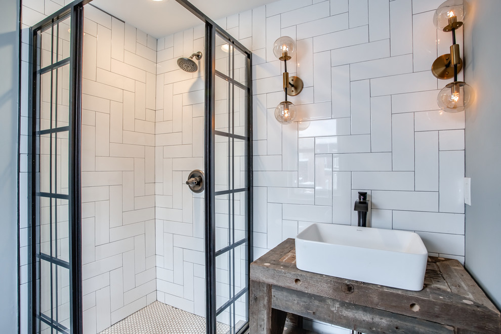 Small rustic shower room bathroom in Philadelphia with open cabinets, medium wood cabinets, a corner shower, white tiles, ceramic tiles, grey walls, a vessel sink, wooden worktops and a sliding door.