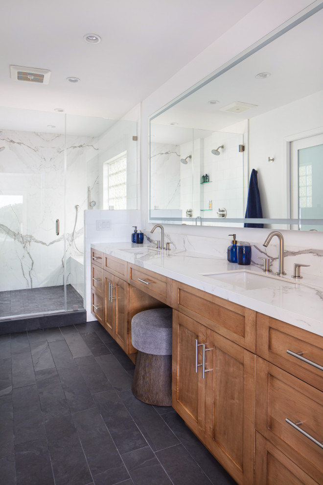 Example of a large mid-century modern master white tile and marble tile slate floor, black floor and double-sink bathroom design in Los Angeles with shaker cabinets, medium tone wood cabinets, a bidet, white walls, an undermount sink, solid surface countertops, a hinged shower door, white countertops and a built-in vanity