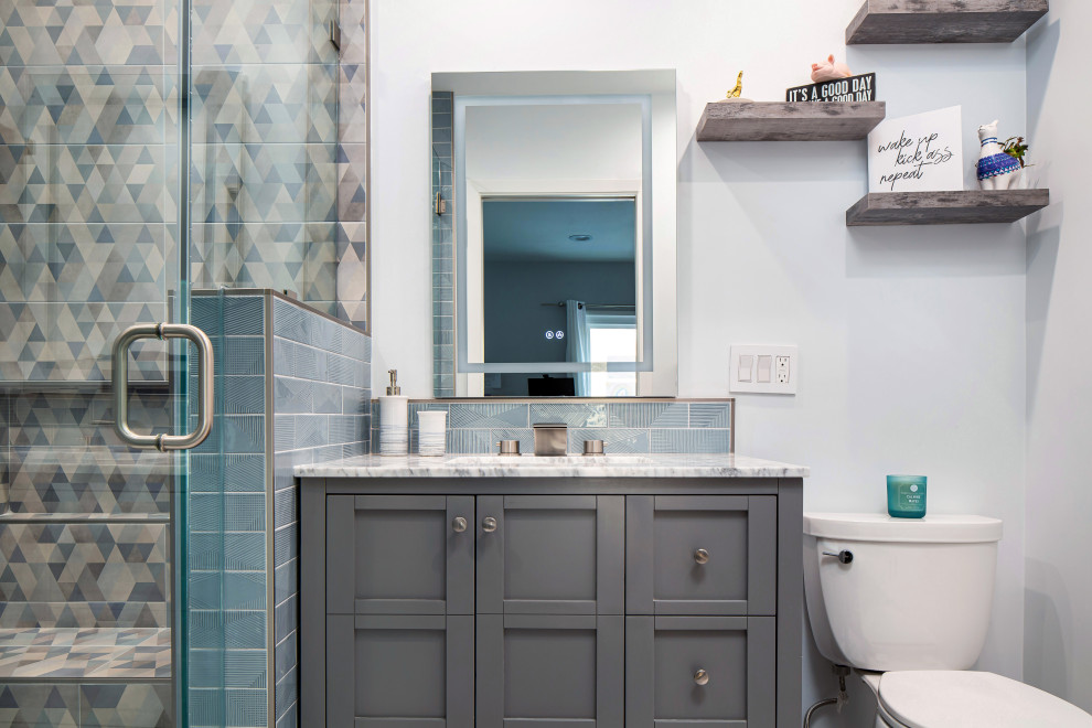 This is an example of a small retro family bathroom in Los Angeles with shaker cabinets, grey cabinets, an alcove shower, a two-piece toilet, blue tiles, ceramic tiles, white walls, marble flooring, a submerged sink, marble worktops, white floors, a hinged door, white worktops, a wall niche, a single sink and a freestanding vanity unit.